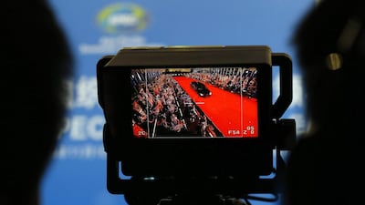 A video monitor shows a limousine carrying APEC leaders arriving for a welcome dinner at the Beijing National Aquatics Centre in Beijing. Ng Han Guan / AP Photo