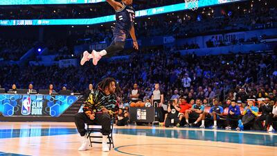 New York Knicks forward Dennis Smith Jr dunks over Recording artist J Cole in the Slam Dunk Contest during the NBA All-Star Saturday Night at Spectrum Center. Bob Donnan-USA TODAY Sports