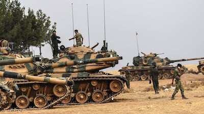 At least 10 Turkish tanks on crossed the border into Syria yesterday. Bulent Kilic / AFP