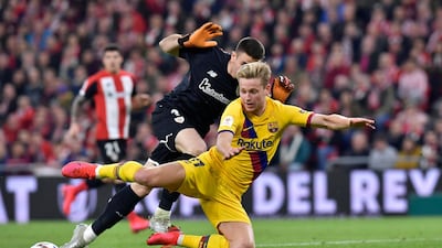 Barcelona's Frenkie de Jong fights for the ball with Athletic Bilbao goalkeeper Unai Simon. AP