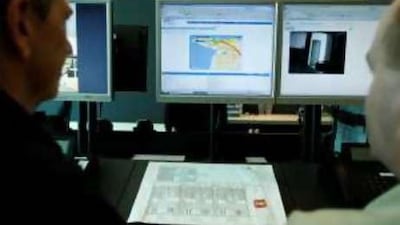 Steven Polifko and Charles Mallice of Adsecc demonstrate a vehicle monitoring system at the company's office.