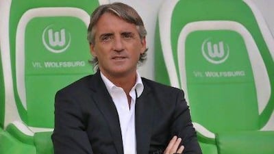 Manchester's Italian headcoach Roberto Mancini reacts before the pre-season friendly football match VfL Wolfsburg vs Manchester City, in Wolfsburg, northern Germany, on August 4, 2012. AFP PHOTO / CARMEN JASPERSEN