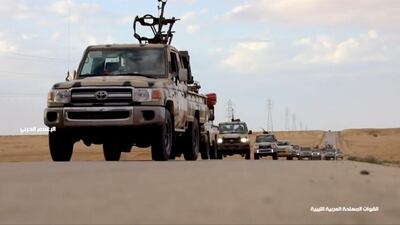 Pickup trucks with mounted weapons drive on a road outside Tripoli. Reuters TV via REUTERS