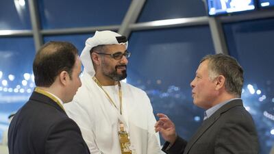 Sheikh Khaled bin Mohammed bin Zayed, centre, speaks with King Abdullah of Jordan, right, during the final race of the 2014 Formula 1 Etihad Airways Abu Dhabi Grand Prix, at Yas Marina Circuit. Ryan Carter / Crown Prince Court — Abu Dhabi