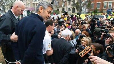 George Clooney and his father Nick, centre, are arrested for trespassing at the Sudanese embassy in Washington.
