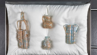 Dima Srouji places replicas of Roman glassware on a soft art-handling pillow. Photo: Ismail Noor, Seeing Things. Courtesy of 421