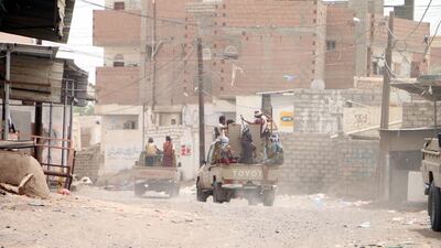 A convoy drives through a built-up area near Hodeidah.