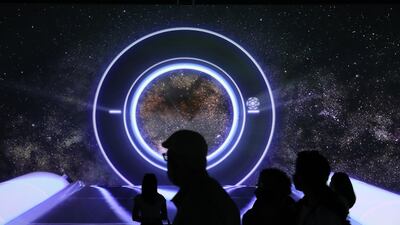 Visitors watch an audio-visual show at the Australia Pavilion at the Expo site in Dubai