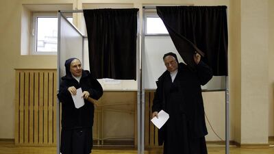 Catholic nuns walk from a booth before casting their votes in a referendum on whether to fire their mayor in Warsaw. Kacper Pempel / Reuters