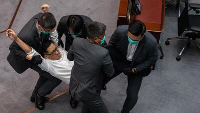 Pro-democracy MP Lam Cheung-ting is carried out of the chamber by security guards during a scuffle with pro-Beijing politicians at a the Legislative Council meeting in Hong Kong, China. EPA
