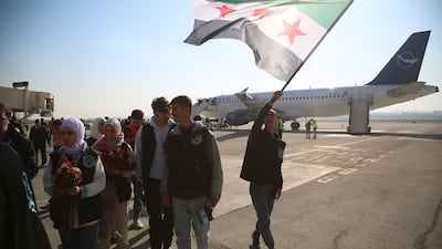 A man waves a Syrian flag at Aleppo Airport, which reopened for the first time since the fall of former ruler Bashar Al Assad six months ago. Syria's people must have confidence that the new government can deliver overall. EPA