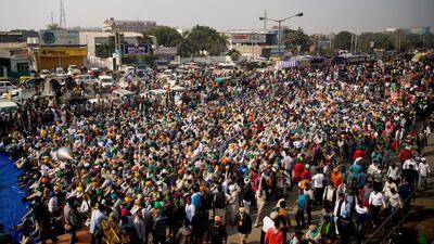 Farmers listen to a speaker as they block a major highway during a protest at the Delhi-Haryana state border, India. Talks between protesting farmers and the Indian government failed. AP