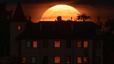 The supermoon rises over a house in the village of Putilovo, near St Petersburg, Russia. AP