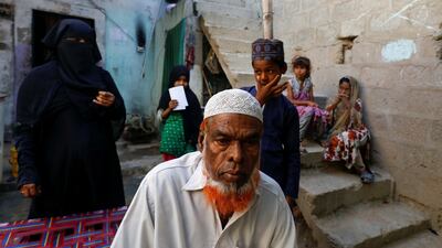 Fisherman Mohammad Sabir, 60, sits at his house with his family during in Ibrahim Hyderi fishing village on the outskirts of Karachi, Pakistan. Reuters