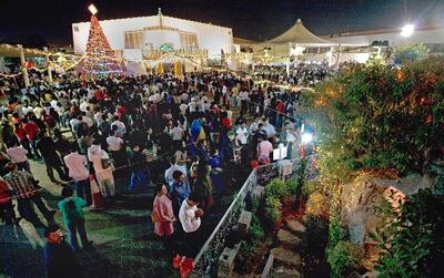 Worshippers congregate in Dubai for Christmas Eve Mass at Saint Mary's Church in Oud Metha. Jeff Topping / The National