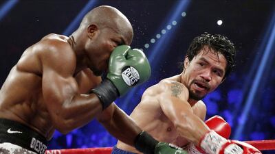 Manny Pacquiao, right, defeats American Tim Bradley Jr during their 2014 rematch to reclaim the WBO world welterweight title. Isaac Brekken / AP Photo