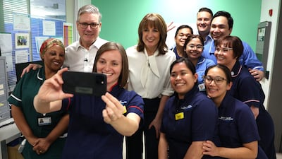 Ms Reeves and UK Prime Minister Keir Starmer with staff at the University College London Hospital after she delivered her budget. PA