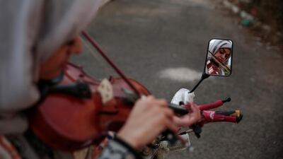 A female Yemeni music student practices playing the violin during a music class at the Cultural Centre in Sanaa, Yemen, on April 8, 2018. For the young people who receive lessons from Abdullah El-Deb'y, music is a safe haven from the misery of Yemen’s devastating war. El-Deb’y offers free lessons to students eager to escape the suffering caused by the war and is seeking to form a national orchestra comprised of young Yemenis. Hani Mohammed / AP Photo