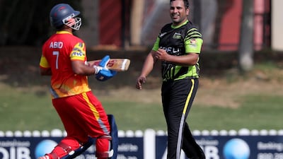 Dubai Pulse bowler Faisal Amin celebrates taking the wicket of Team Abu Dhabi's Ali Abid.