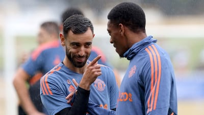 Manchester United midfielder Brun Fernandes, left, talks to teammate Anthony Martial during a training session in Perth on July 21, 2022, ahead of their tour match against Aston Villa. AFP