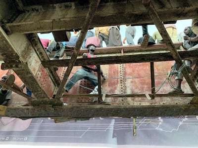 A Sudanese man beats time on a steel rail crossing for chanting crowds at the sit-in outside the army headquarters in Khartoum. Hamza Hendawi for The National