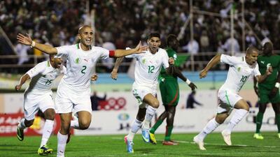 Algeria’s Madjid Bougherra, centre, celebrates the deciding goal against Burkina Faso with teammates during 2014 World Cup qualifying. Farouk Batiche / AFP