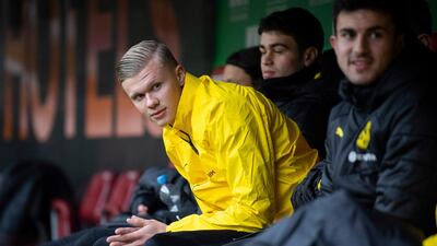 Erling Haaland sits on the bench during the game between Dortmund and Augsburg. AP