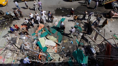 Iraqis inspect the aftermath of a late-night car bombing near a cafe in the Shiite Al Amin neighbourhood in eastern Baghdad. The country’s deadliest wave of violence in more than two years shook more than a dozen Iraqi cities this week.