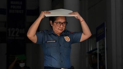 A policewoman leaves a building in Manila after the quake struck. AFP