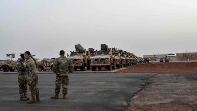 American soldiers prepare military vehicles to be loaded on to a cargo plane in Niamey as US troops begin to leave Niger in June. AFP