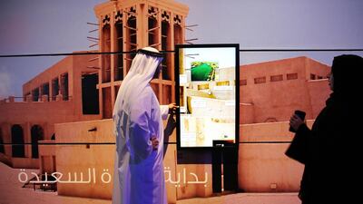 Employees use a touchscreen display on a wall in Dubai. Kamran Jebreili / AP Photo