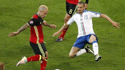 Belgium's Radja Nainggolan is challenged by Italy's Leonardo Bonucci during the Euro 2016 Group E match between Belgium and Italy at the Grand Stade in Decines-Charpieu, near Lyon, France, Monday, June 13, 2016. Michael Sohn / AP Photo