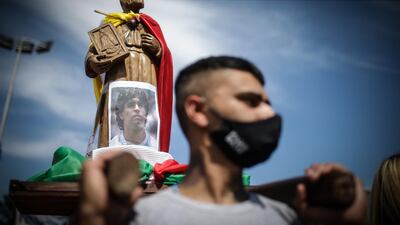 A man carries a photo of Maradona at Villa Palito neigborhood in La Matanza municipality, Buenos Aires. EPA
