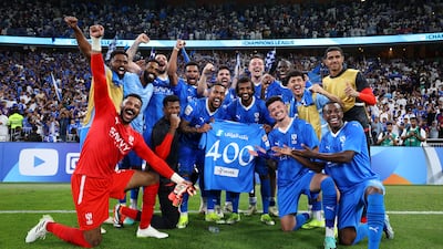 Al Hilal pose for a photo whilst holding a match shirt to celebrate the 400th appearance for Yasser Al-Shahrani. Getty Images)