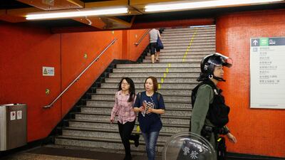 Passengers walk descend a flight of steps inside North Point station. Bloomberg