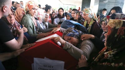Relatives of Turkish diplomat Osman Kose cries on his coffin during his funeral ceremony in Ankara, Turkey, 18 July 2019. EPA