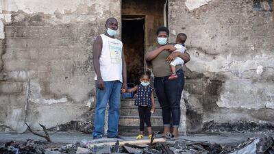 The Akinmoladun family sift through the ruins of their furniture store. Antonie Robertson / The National