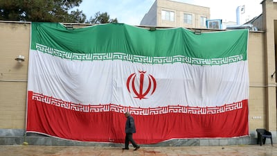 An Iranian flag hangs from the wall of a mosque in Tehran. EPA