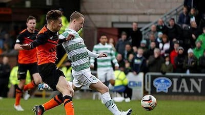 Celtic's Leigh Griffiths, right, scores against Dundee United during their Scottish Premier League match at Tannadice Park Stadium in Dundee, Scotland on December 21, 2014. REUTERS/Russell Cheyne