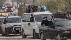 Displaced people make their way back to their homes after crossing the bridge linking southern Lebanon to the rest of the country. Reuters