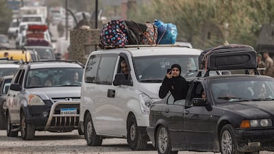 Displaced people make their way back to their homes after crossing the bridge linking southern Lebanon to the rest of the country. Reuters