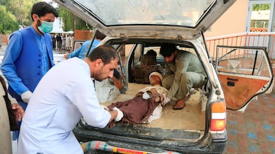 Men carry an injured person to a hospital after a blast at a mosque in Afghanistan's Nangarhar province on October 18, 2019. Reuters
