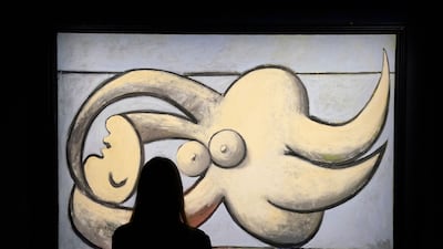 A woman poses in front of Pablo Picasso’s “Femme nue couchée" during the New York press preview on May 6, 2022, of Sotheby's Macklowe Collection spring auction. (Photo by TIMOTHY A. CLARY / AFP) / RESTRICTED TO EDITORIAL USE - MANDATORY MENTION OF THE ARTIST UPON PUBLICATION - TO ILLUSTRATE THE EVENT AS SPECIFIED IN THE CAPTION