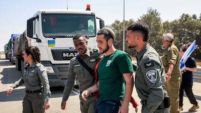 Israeli police detain an activist from blocking lorries carrying humanitarian aid into the Gaza Strip near Karam Abu Salem crossing in southern Israel. AFP