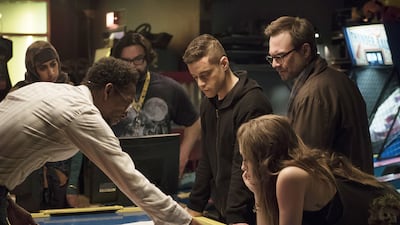 In the foreground from left, Ron Cephas Jones as Romero, Rami Malek as Elliot, Christian Slater as Mr Robot and Carly Chaikin as Darlene in Mr Robot. USA Network / NBCU Photo Bank via Getty Images
