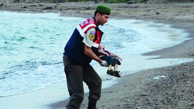 A Turkish gendarmerie carries a young migrant, who drowned in a failed attempt to sail to the Greek island of Kos, in the coastal town of Bodrum, Turkey on September 2. At least 11 migrants believed to be Syrians drowned as two boats sank after leaving southwest Turkey for the Greek island of Kos, Turkey’s Dogan news agency reported on Wednesday. Reuters / Nilufer Demir / DHA