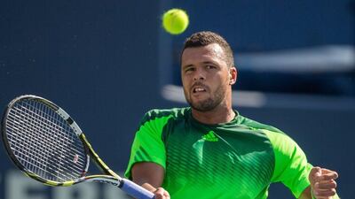 Jo-Wilfried Tsonga returns a shot to Roger Federer of Switzerland during Tsonga 7-5, 7-6 victory in the final of the Rogers Cup at Rexall Centre in Toronto, Ontario, August 10, 2014. AFP PHOTO / Geoff Robins