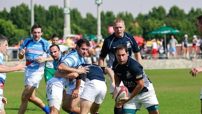 Gulf Legends (dark blue) v Airbus (light blue stripes) during Day 1 of the Emirates Airlines Dubai Rugby Sevens at The Sevens in Dubai on Thursday. Victor Besa for The National