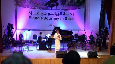 Japanese pianist Kaoru Imahigashi plays the piano while opera singer Fujiko Hirai, right, performs during a concert to mark the debut of Gaza's only grand piano after it was rescued from conflict, at a theatre nestled in the Palestinian Red Crescent Society's building in Gaza City. AP Photo