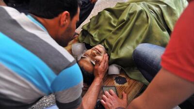 Family and friends mourn over the body of Usame Mircan, who was allegedly killed by a Syrian government sniper. Bulent Kilic / AFP Photo